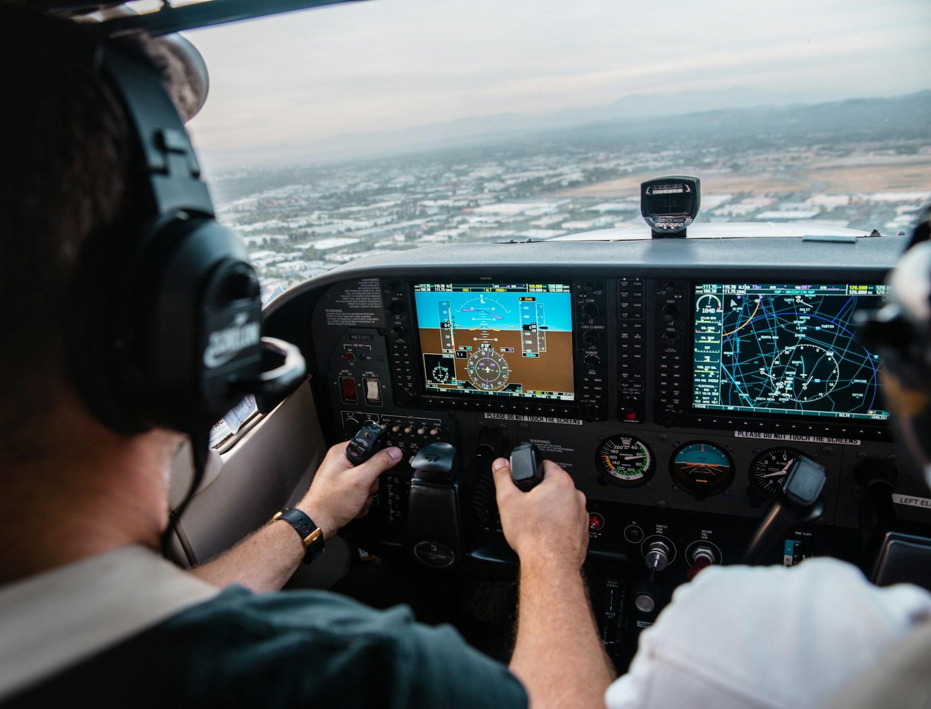 Over the shoulder view of pilots flying an aircraft